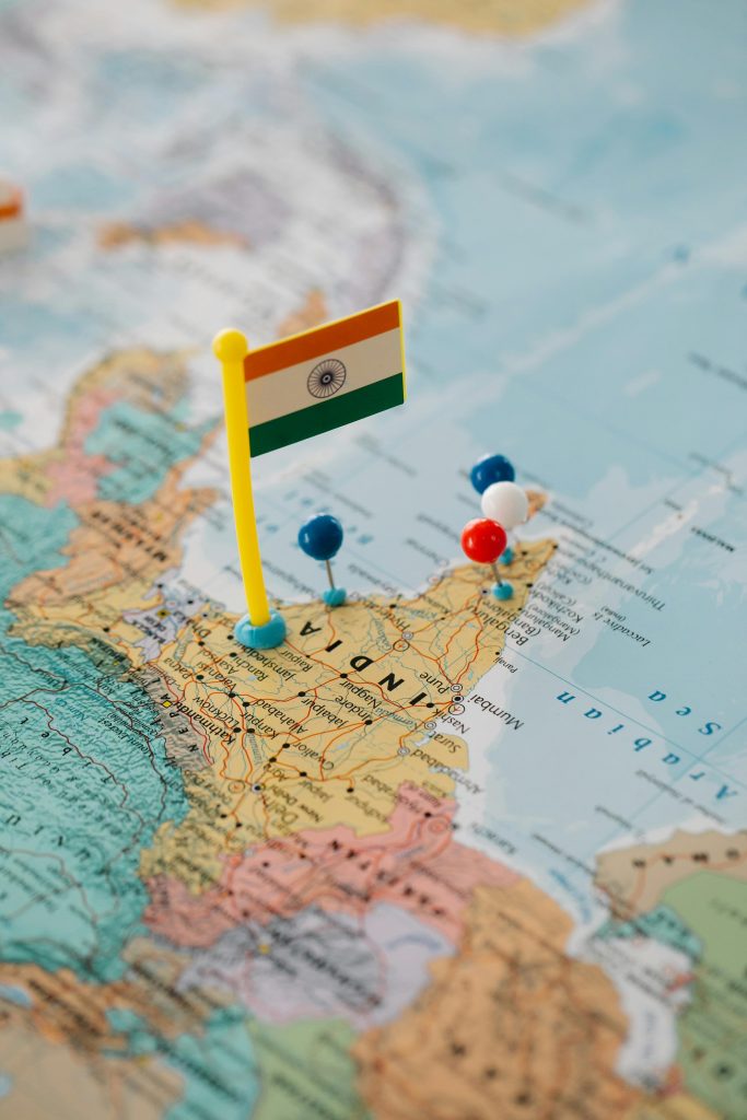 pexels-photo-8828354-8828354 Indian map close-up with a flag and multiple colored pushpins.